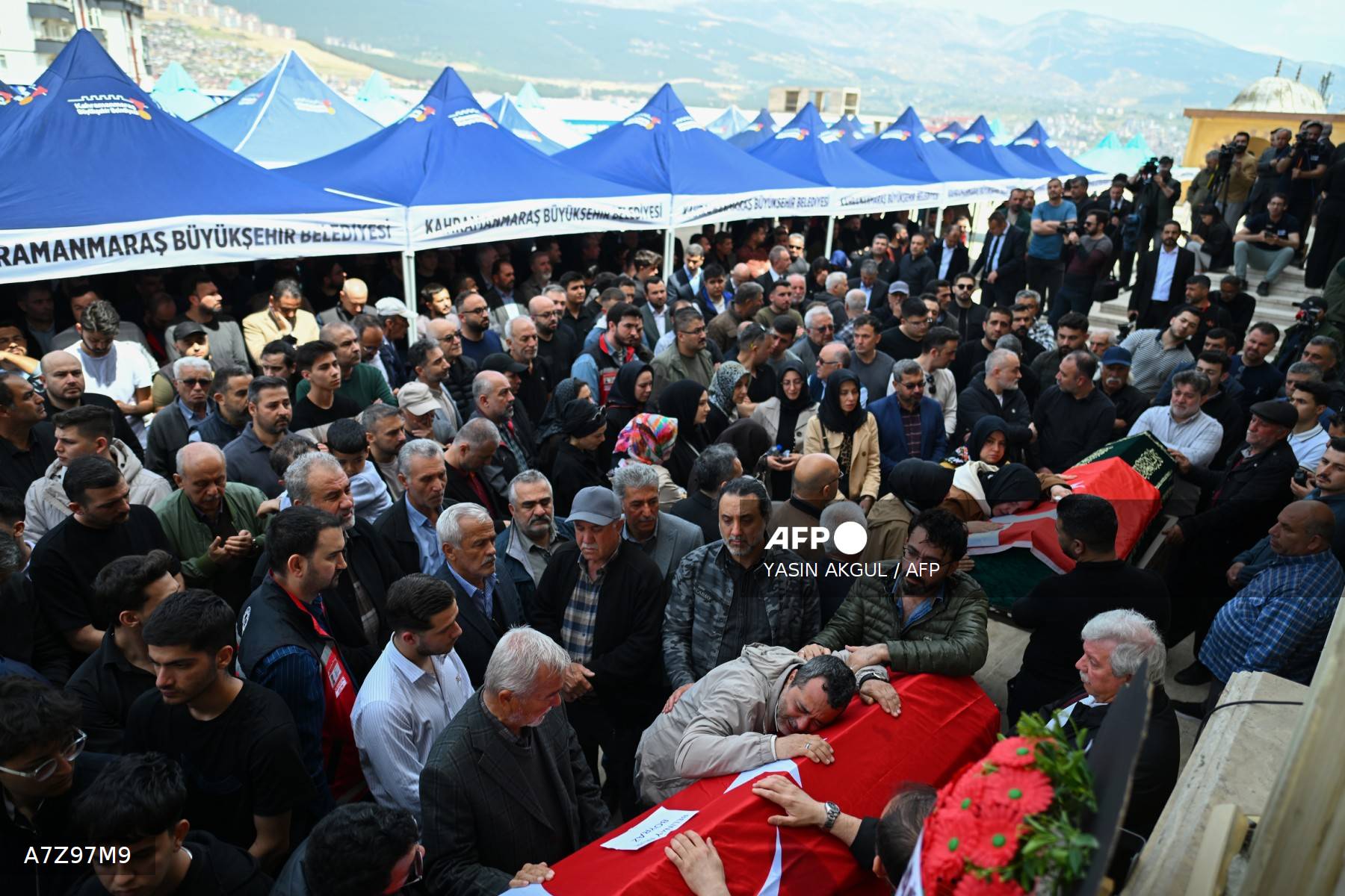 Funérailles collectives à Kahramanmaraş sous les tentes bleues de la municipalité, cercueils drapés du drapeau turc et foule massive rassemblée le 16 avril 2026